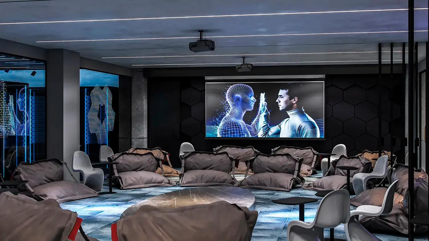 Modern gaming lounge with bean bag seating, gaming chairs, large screen displaying digital avatars, blue neon accents, and futuristic interior design.