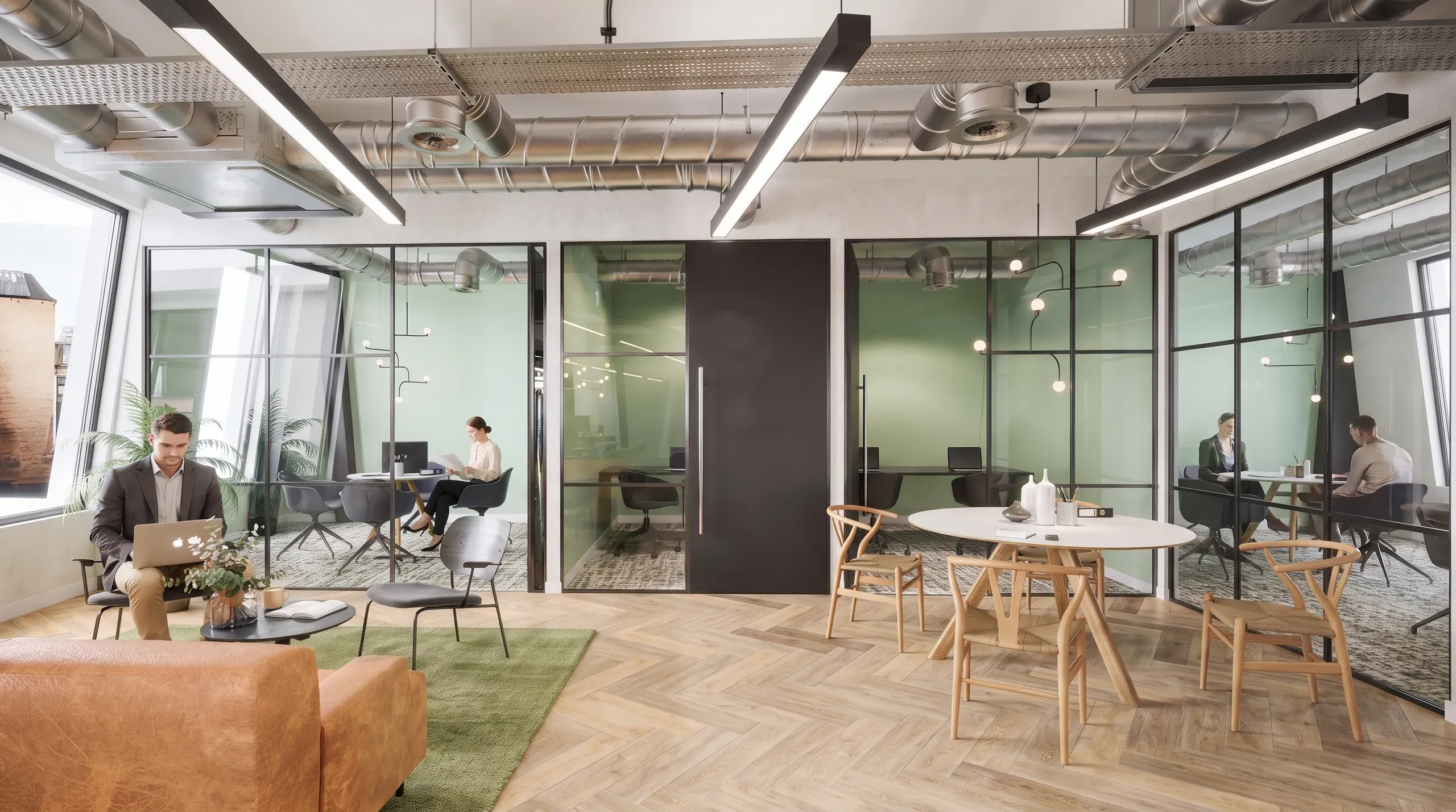 Modern open-plan office with glass-partitioned workspaces, wooden furniture, green accent walls, and employees working at desks and tables.