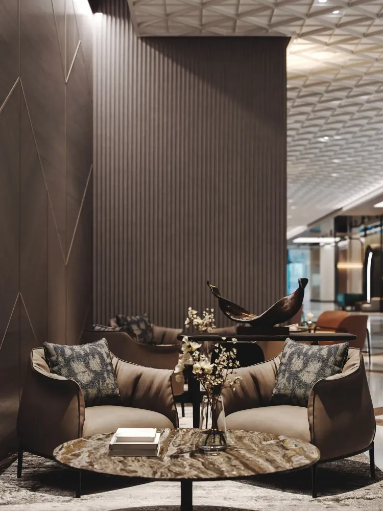 SIRO seating area with bronze bird sculpture, velvet chairs, and marble table