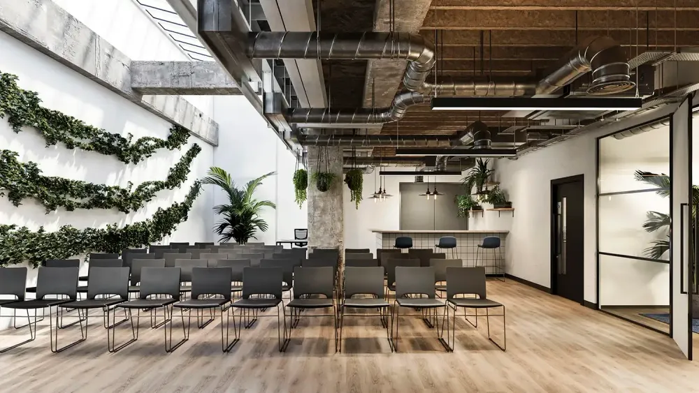 3D rendering of industrial coworking space with exposed ductwork and café