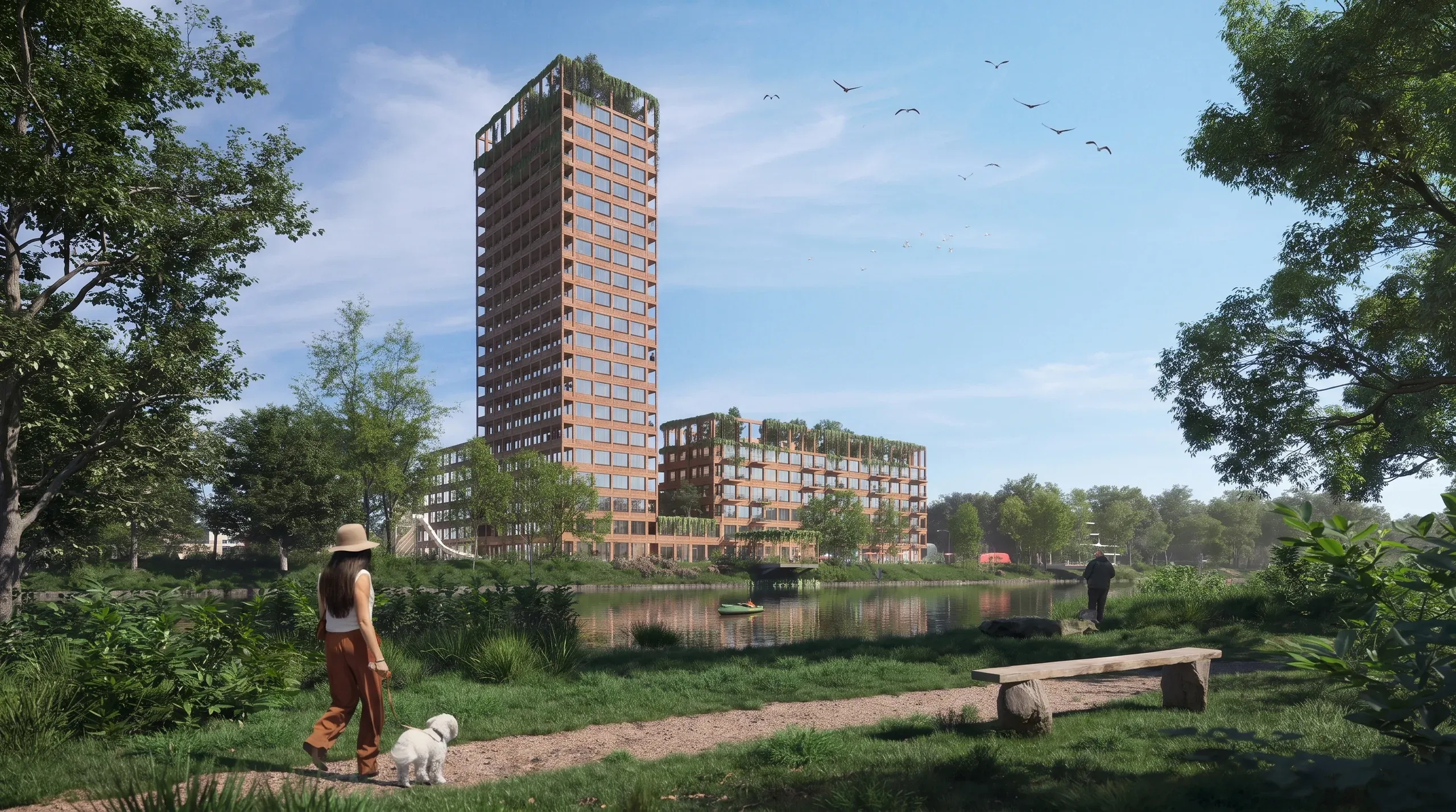 Modern waterfront residential development with red brick towers, riverside park with walking paths, benches, and green landscaping.