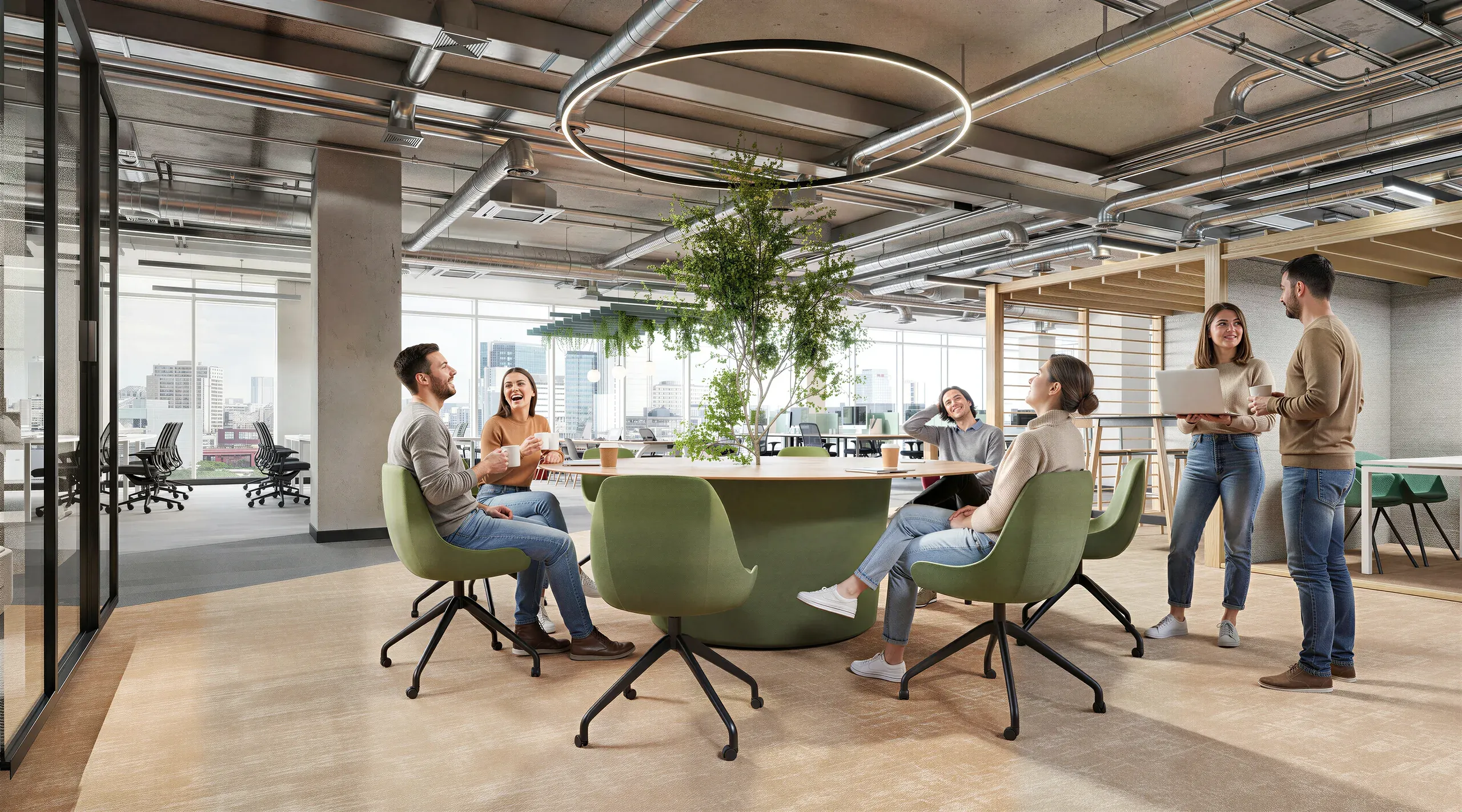 Modern office space with employees collaborating in an open floor plan featuring green chairs, natural lighting, indoor plants, and city views through large windows.