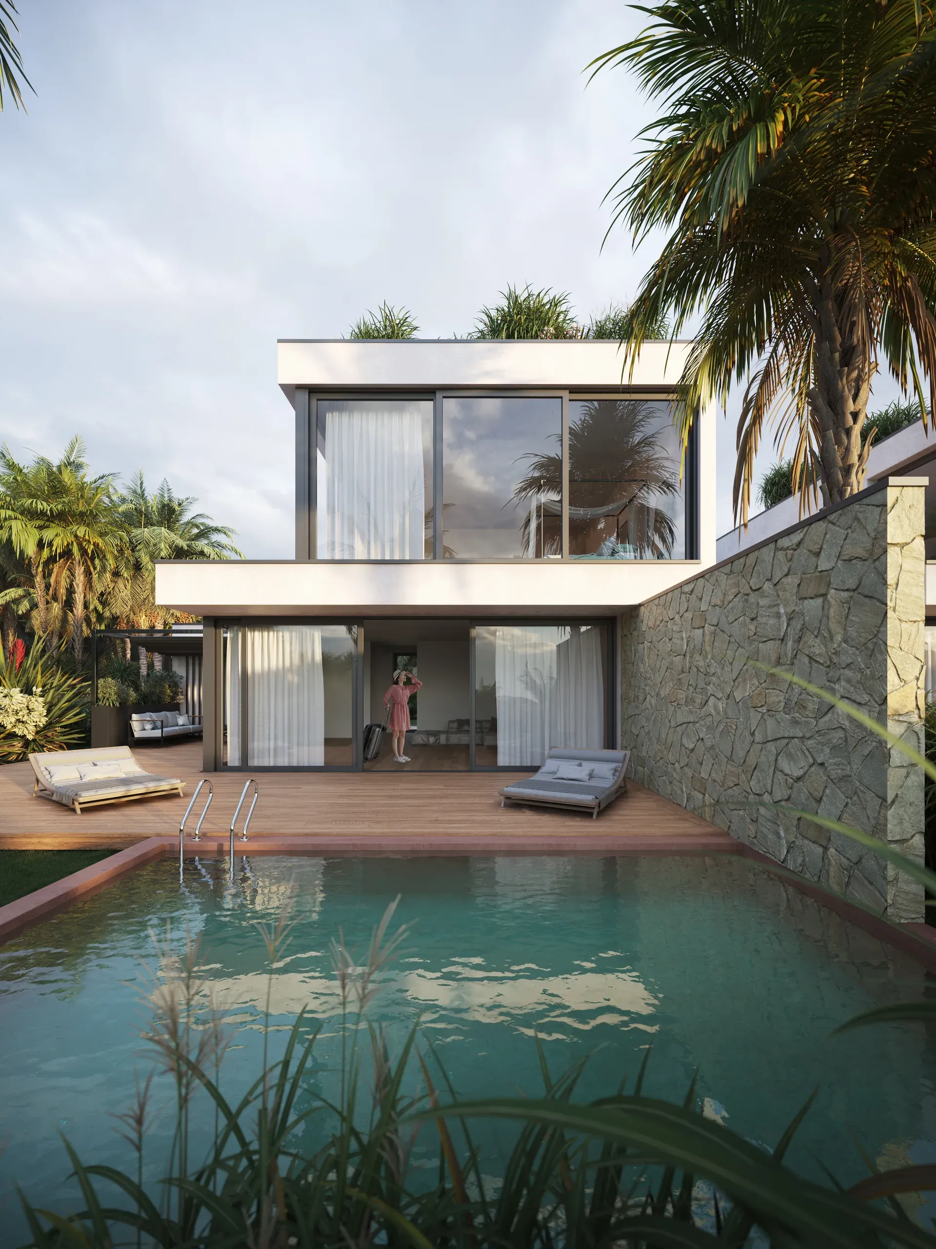Modern two-story house with white facade, large glass windows, wooden deck, swimming pool, stone wall, and tropical palm trees surrounding the property.