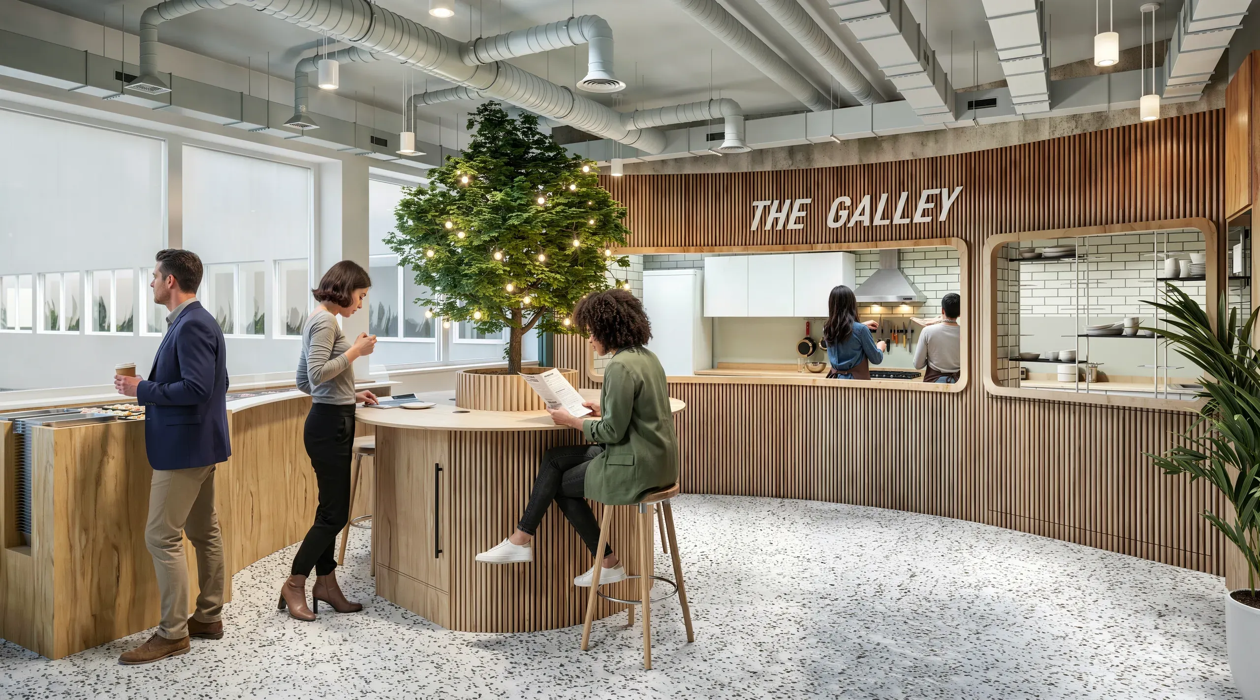 Modern office break room with wooden accents, decorated Christmas tree, kitchen counter labeled "The Gamey," and employees socializing and working.