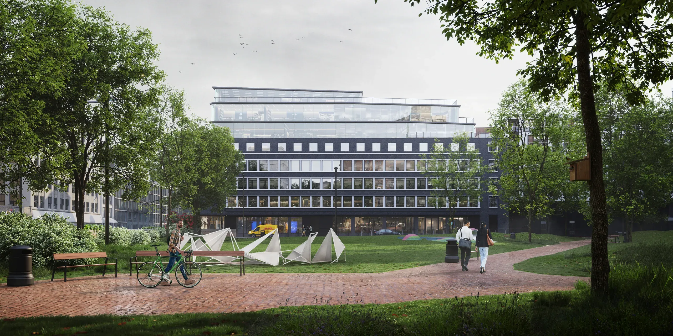 Modern multi-story building with glass upper levels and dark facade, surrounded by green courtyard with people, bikes, and tent structures.