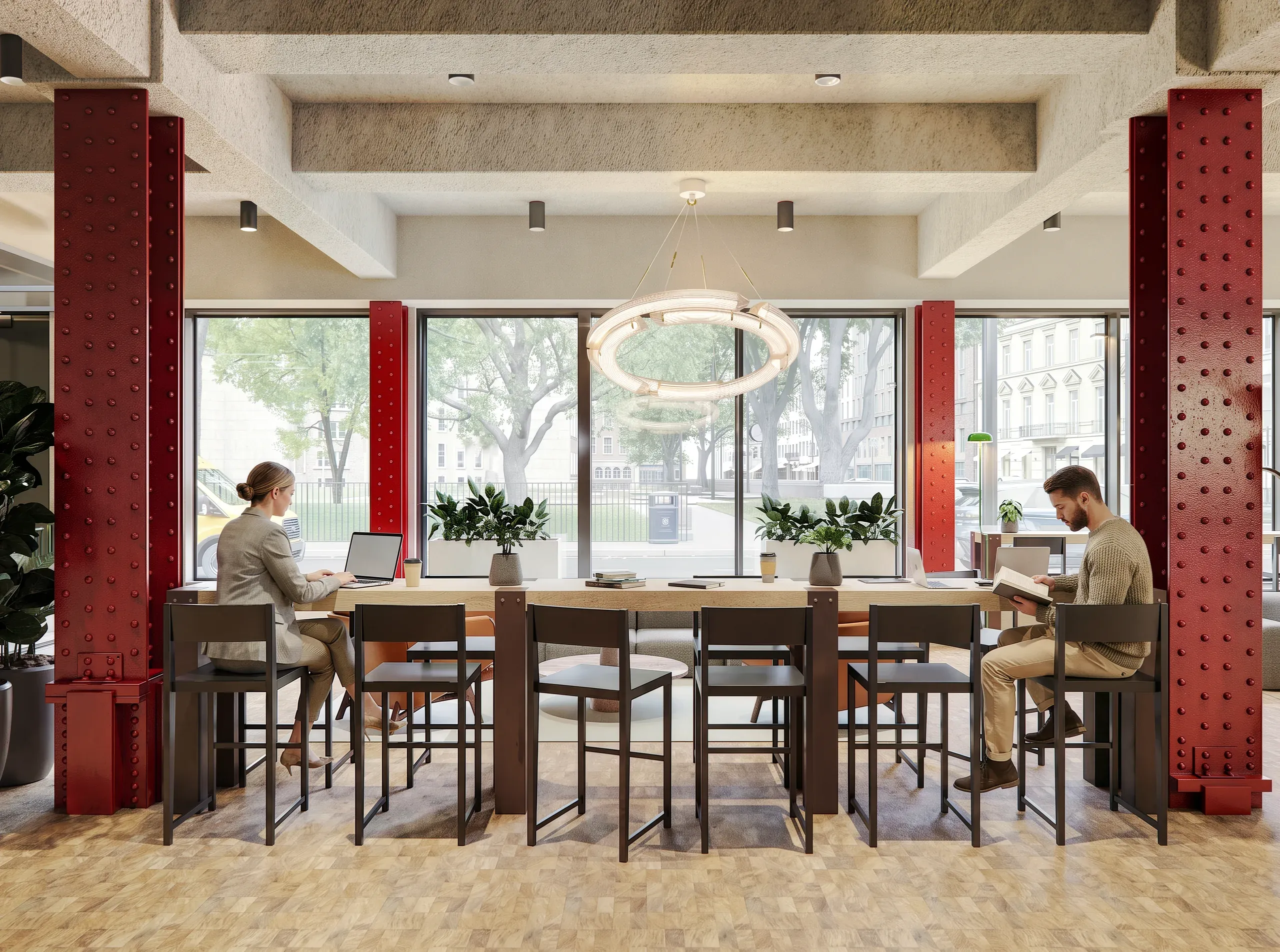 Modern office space with two people working at a long desk by floor-to-ceiling windows, red industrial columns, pendant lighting, and urban views.