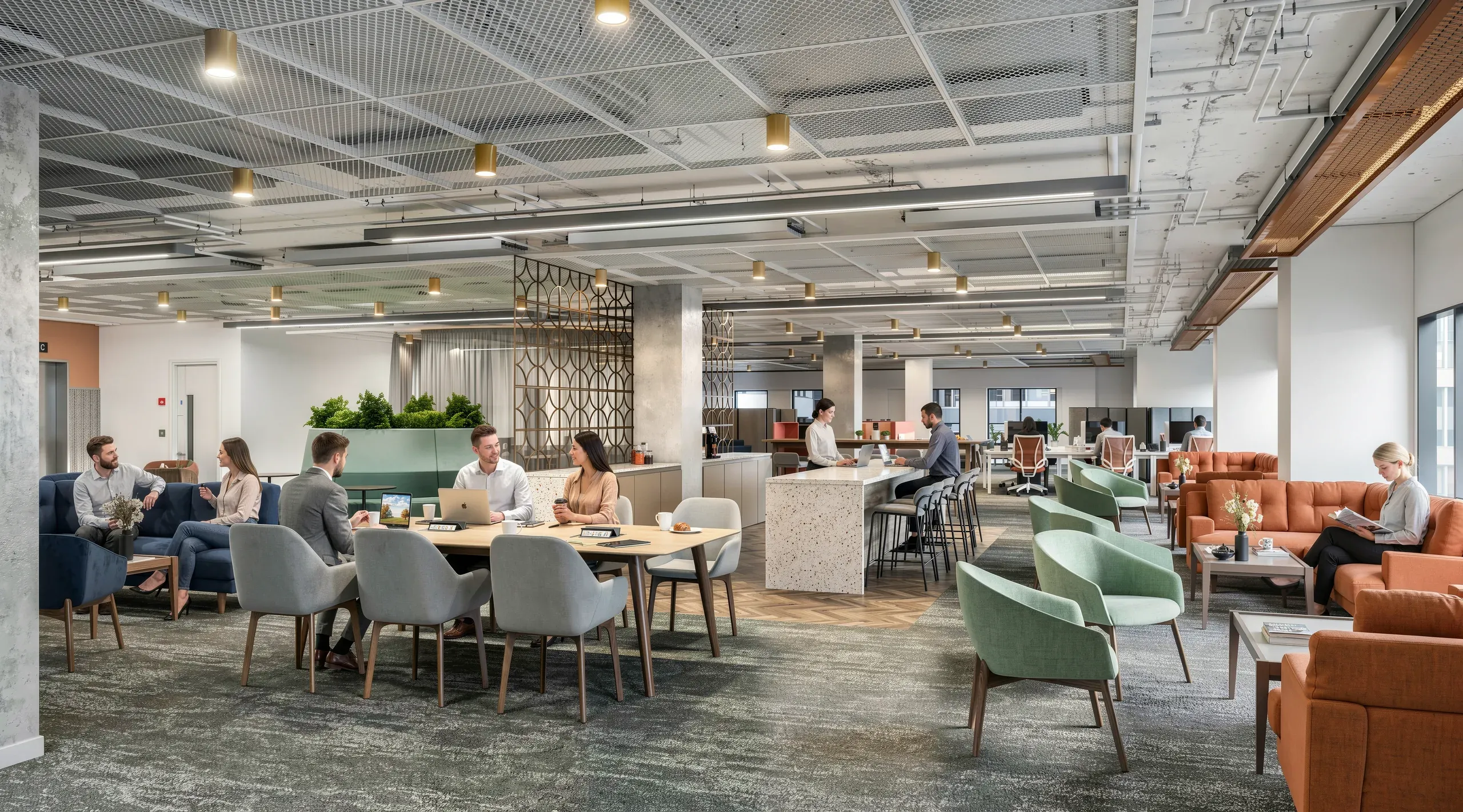 Modern open-plan office space with collaborative seating areas, lounge furniture in blue and orange tones, workstations, and natural lighting from ceiling fixtures.