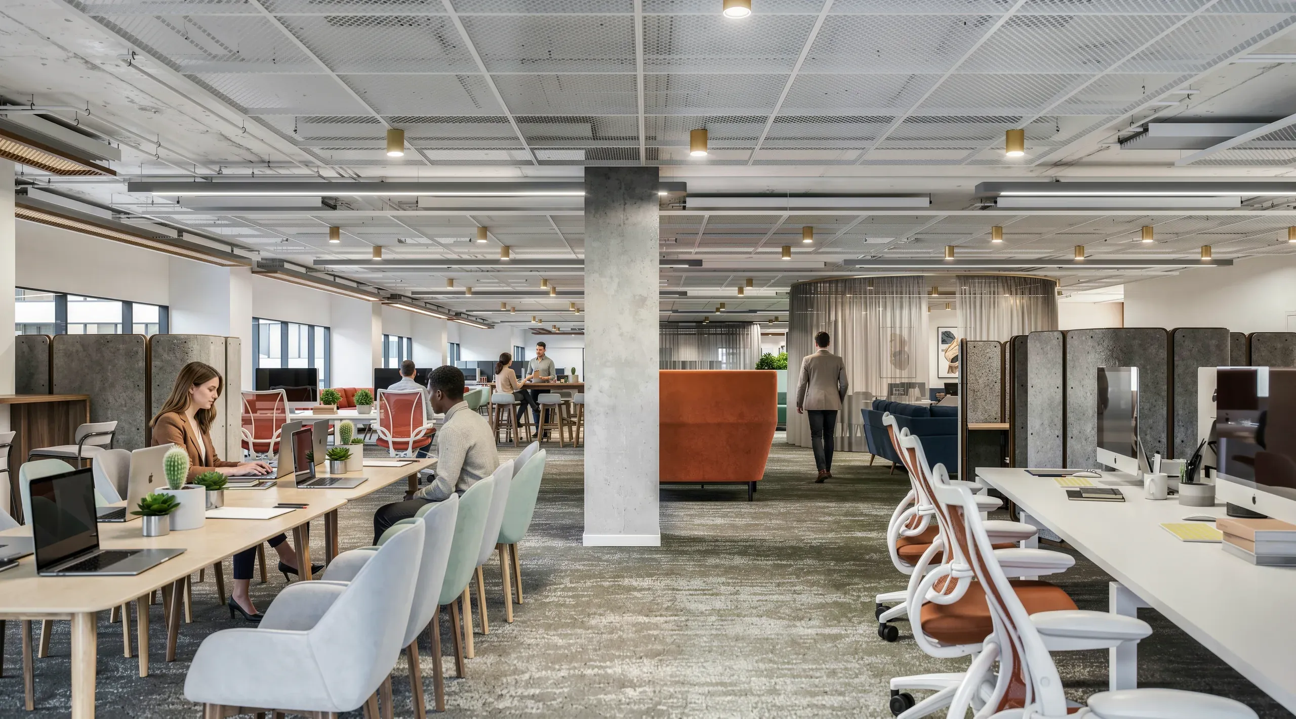 Modern open-plan office space with collaborative workstations, casual seating areas, concrete columns, and natural lighting throughout the industrial-style interior.