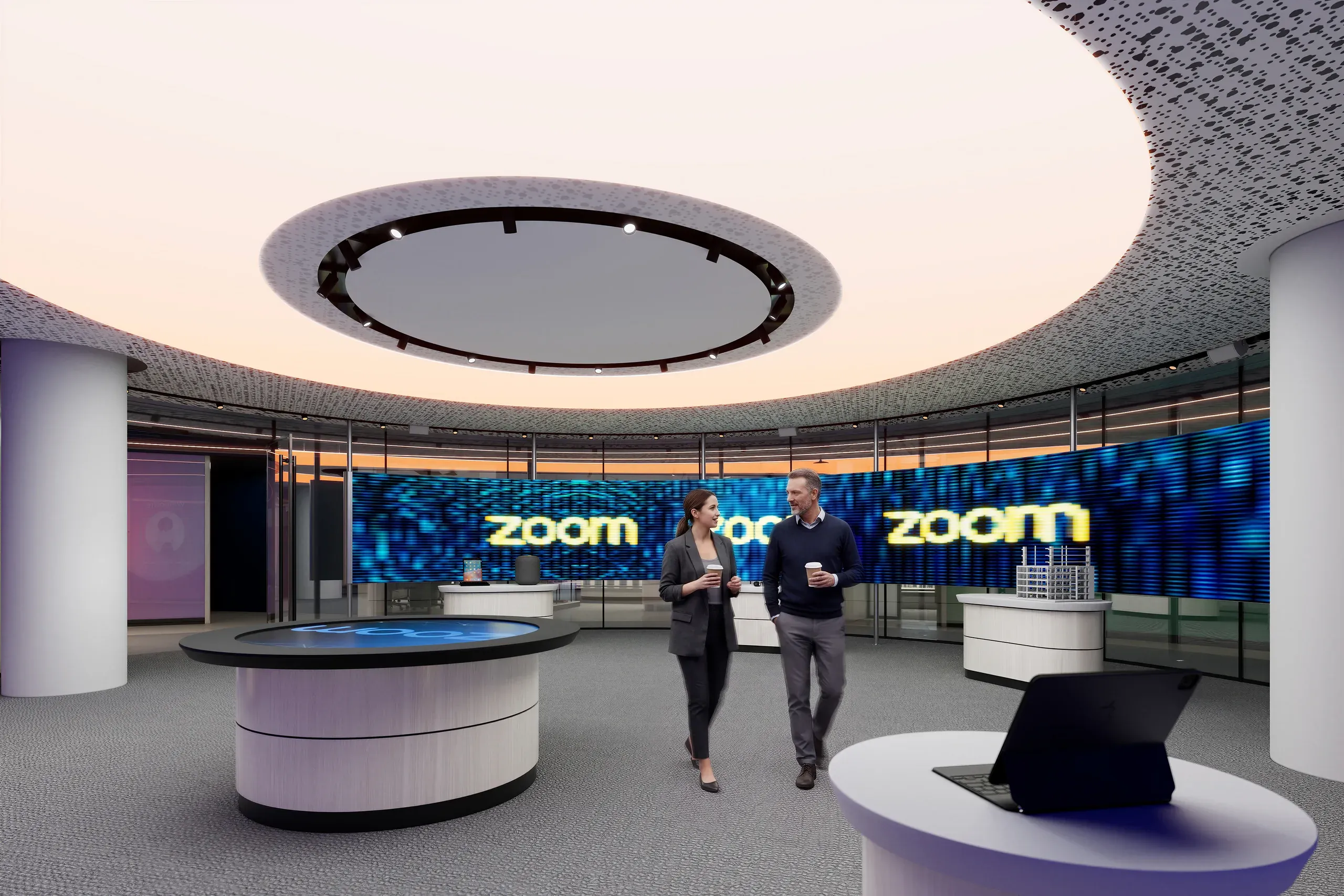 Modern circular office space with "zoom" branding on blue LED wall, two people conversing, white cylindrical desks, and large skylight ceiling.