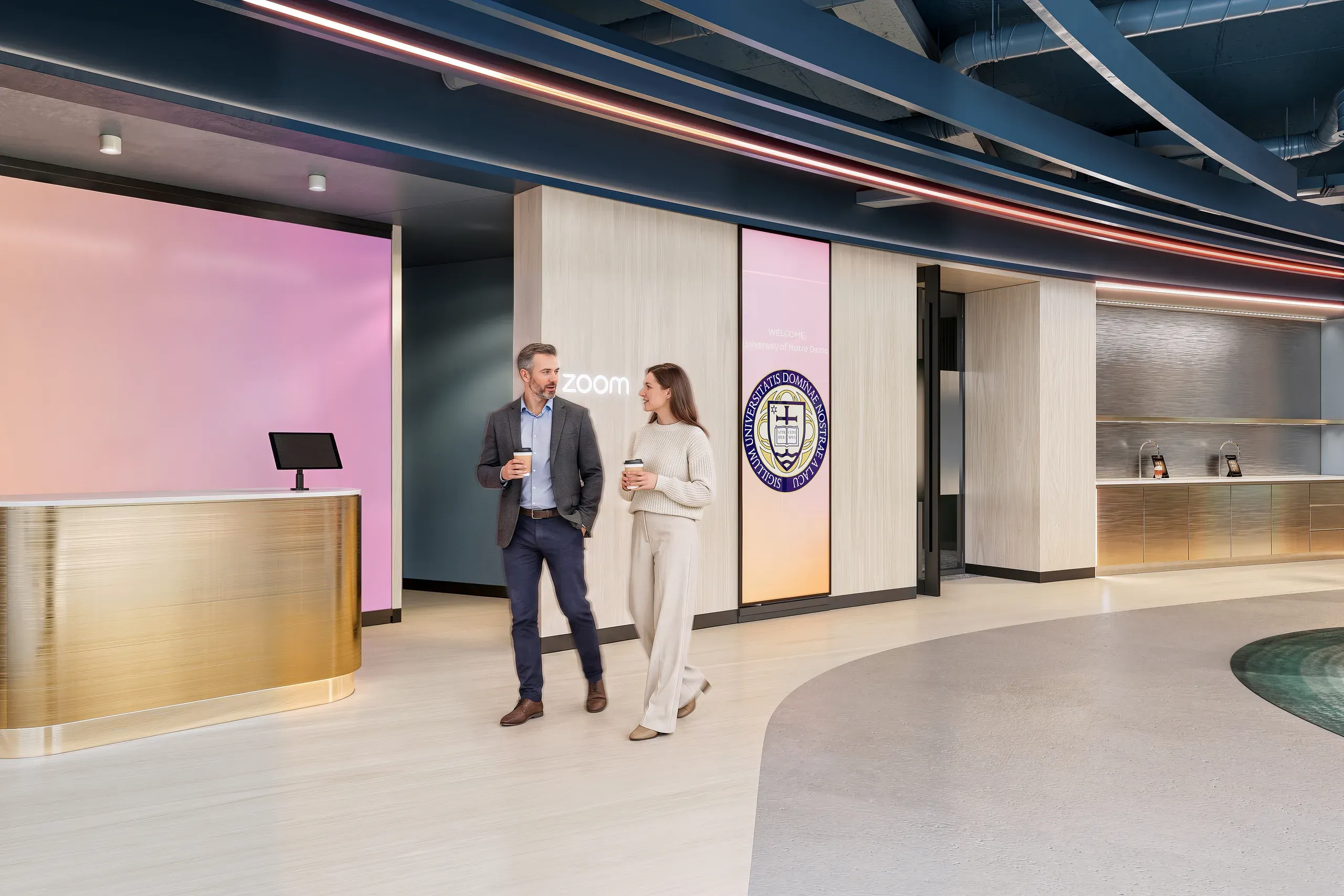 Modern office lobby with two professionals conversing, featuring pink accent wall, Zoom signage, wooden reception desk, and institutional seal on partition wall.